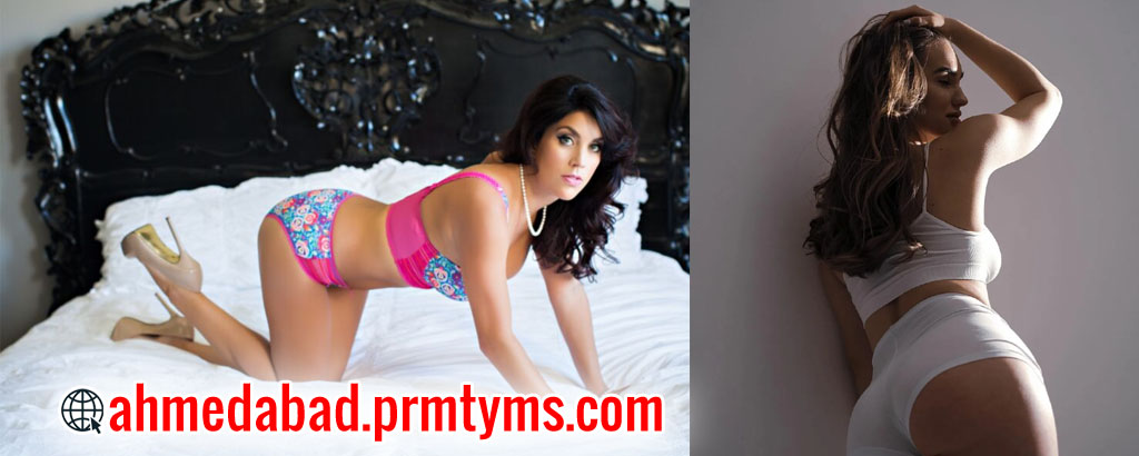 Two women posing in lingerie, one on a bed in colorful lingerie and the other standing against a wall in white lingerie, with text 'ahmedabad.prmtyms.com' displayed.