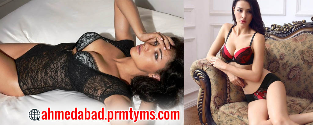 Two women in lingerie posing indoors, one lying on a bed and another sitting on a sofa